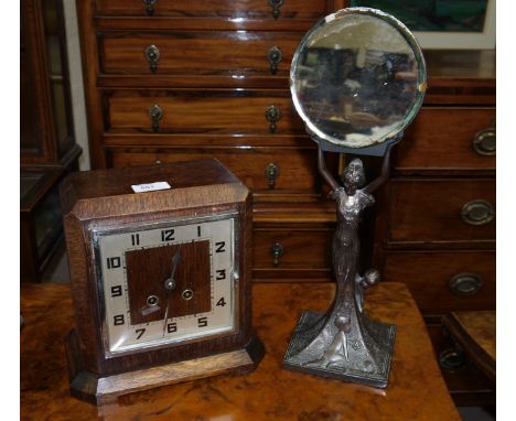 A 1930's oak Westminster chiming mantel clock; a bronzed Art Deco style female figure holding a mirror
