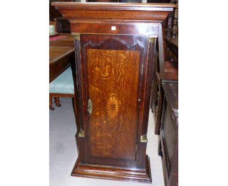 A wall cabinet formed from the trunk of a longcase clock