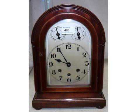 An Edwardian mahogany arch top mantel clock with silvered dial and chiming 8 day movement, height 13½"