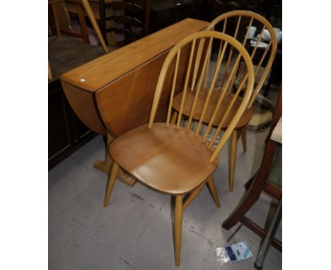 A modern Ercol light elm dining suite comprising narrow oval drop leaf table, and 4 hoop and stick back chairs