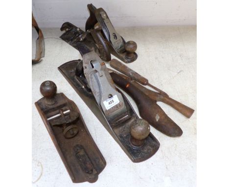 A large metal Stanley plane; a similar smaller plane; other planes and tools