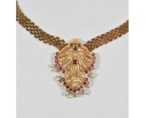 A ruby and half pearl pendant necklace  the pierced and engraved panel suspending a fringe of baroque pearl drops, on a brick