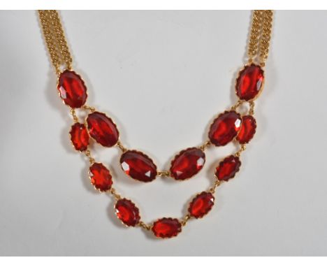 A pendant necklace  centred with two rows of graduated oval-cut red pastes, to a yellow metal curb-link back chain, 18ct gold