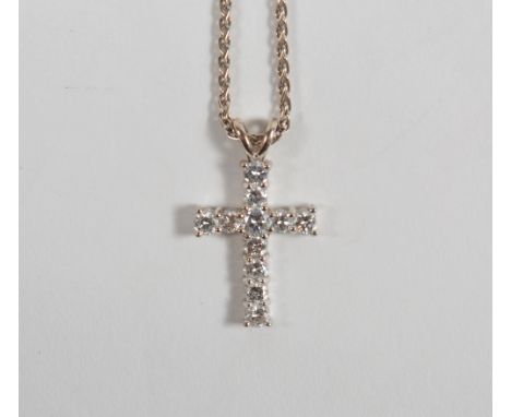 A diamond cross pendant the round briliant-cut diamonds in claw setting, 18ct white gold mounted, suspended from an 18ct whit