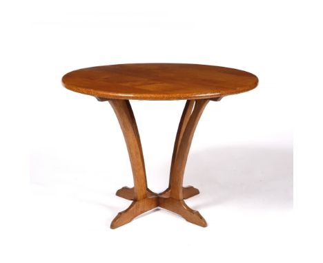 A light oak occasional table on shaped base, 63cm diameter