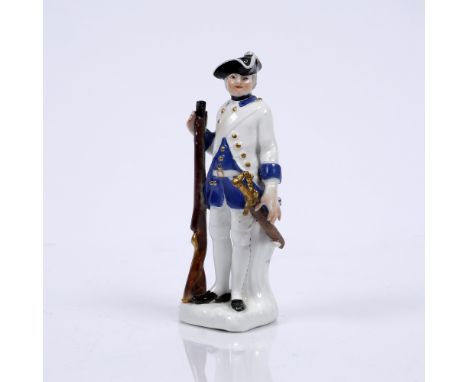 A Meissen figure of a soldier  circa 1750, standing with a musket in his right hand, a sword at his side, highlighted in gild
