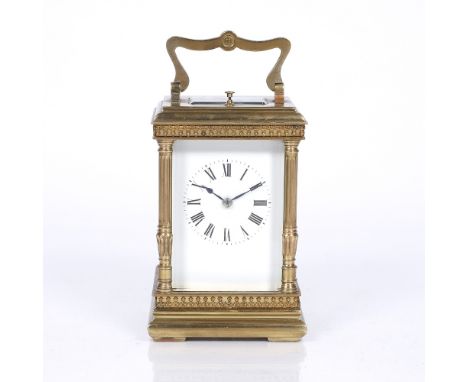 A French brass carriage clock with white enamel Roman dial, silvered platform lever escapement and coiled gong strike with pu
