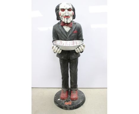 Composite Jigsaw Saw statue in standing position with arms out holding kidney dish with blood splatter, showing cracks, paint