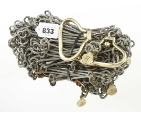 An unusual and little used 30 metre measuring chain the brass handles and tallies marked RABONE CHESTERMAN G+