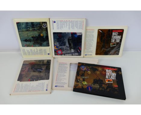 Philately - Five United States Postal Service World War Two (WW2 / WWII) related commemorative books and mint stamps comprisi