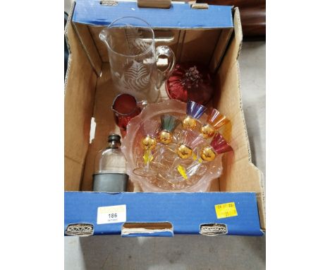 Box of glassware, cranberry glass jug and lidded dish, hip flask, etc. 