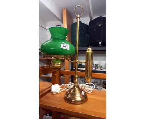 A brass student lamp with green glass shade