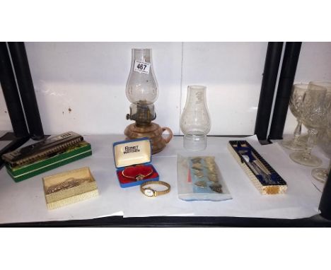 A mixed lot including oil lamp with chimneys, boxed harmonica, watches, RAF tie pin etc