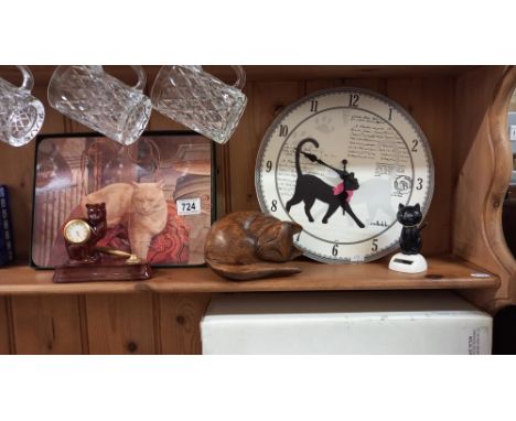 A cat clock, wooden cat, and  other cat related items