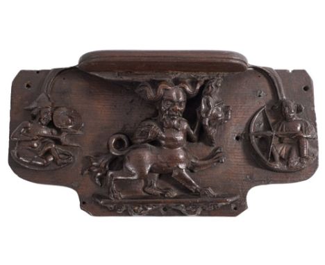 A late 14th/early 15th Century carved oak misericord:  the seat supported by a manticore with lion-mask shield, his weapon no