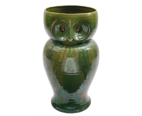 An zoomorphic pottery stick stand: attributed to Bourne Denby and in the form of an owl with incised detailing under green gl