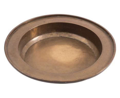 A late 17th/early 18th Century brass basin: of plain circular form with applied solid rim, 42.5cm diameter. 