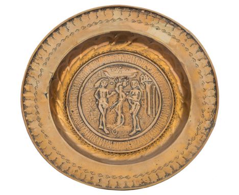 A 16th/early 17th Century Nuremburg brass alms dish: the central panel depicting  Adam and Eve within a band of text, 39.5cm 