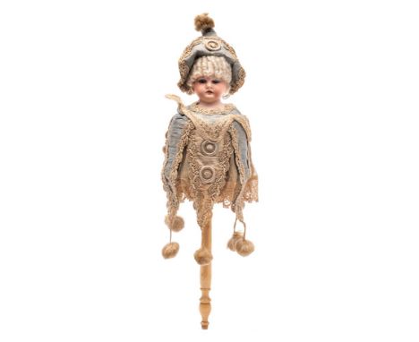 A late 19th/early 20th Century German bisque head musical spinning doll: impressed 3200, with fixed blue eyes, open mouth wit