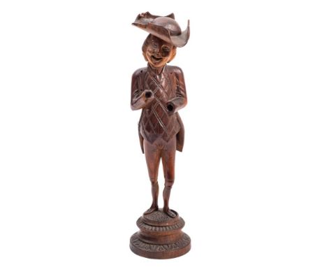 A 19th Century Swiss or Austrian novelty nutcracker: carved as a gentleman wearing a tail coat, waistcoat and tricorn hat, on