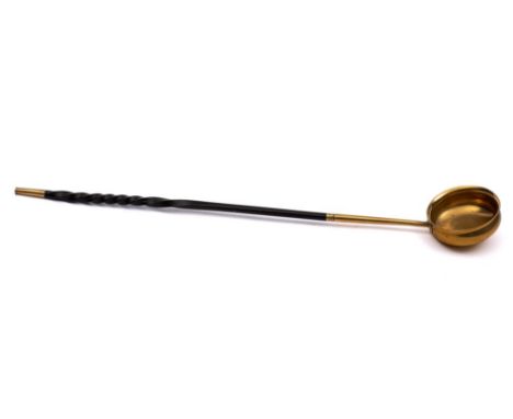 A mid 18th Century gilded brass toddy ladle: with twisted horn handle. 45cm long.*Note    A similar example is illustrated in