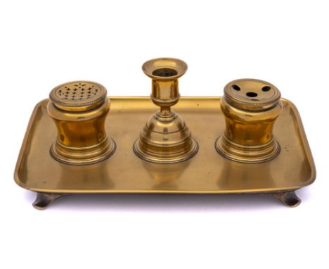 An early to mid 18th Century brass ink standish: of rectangular form, the central lift-off candlestick enclosing  a circular 