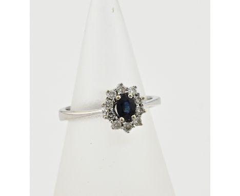 White gold ring, 585/000, with sapphire and diamond. Rosette ring, Lady Di, with an oval faceted blue sapphire in the center 