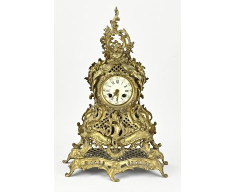 Antique French brass mantel clock. Neo rococo. Circa 1890. Eight-day movement, half-hourly strike, with spring pendulum. Glas