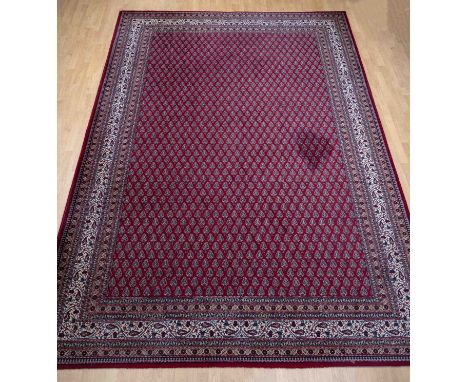 Large Persian carpet. Red with light border. Size: 250 x 350 cm. Small stain in the middle. Otherwise in good condition.