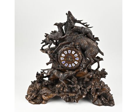 19th century walnut carved black forest mantel clock with finely detailed figures, red deer/wolves. Eight-day movement, half-
