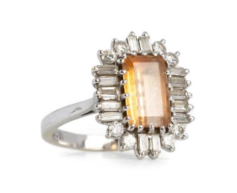 GEMSTONE AND DIAMOND CLUSTER RING, EIGHTEEN CARAT WHITE GOLD the central emerald cut cinnamon-tinted stone, likely imperial t