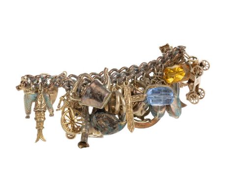 GOLD CHARM BRACELET, the charms including flintlock pistol, football, miniature thimble and others, some marked for goldQty: 