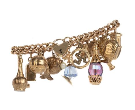 CHARM BRACELET, NINE CARAT GOLD  with numerous charms including a fish, musket, teapot and football attached to a curb link b