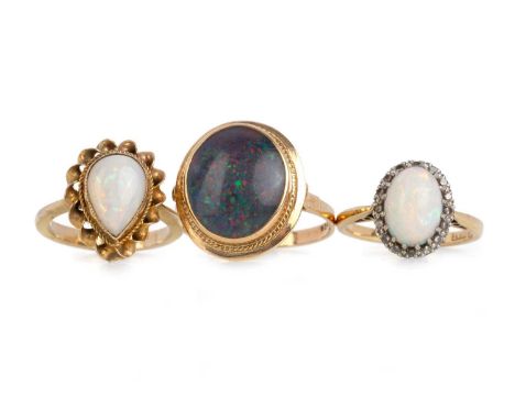 THREE OPAL RINGS, one set with a cabochon oval opal in a surround of small diamonds with eighteen carat gold shank, along wit