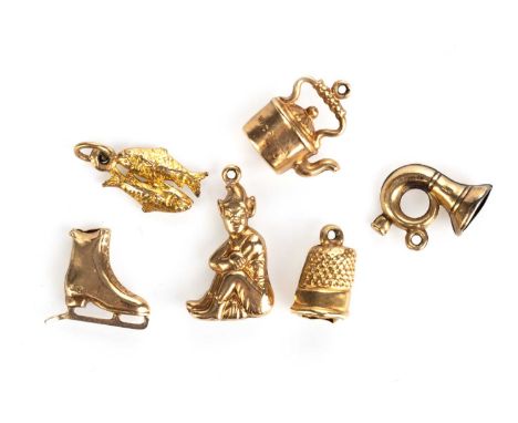 GROUP OF SIX CHARMS, NINE CARAT GOLD  including a miniature thimble, ice skate, kettle and fish Qty: 3.87g gross 