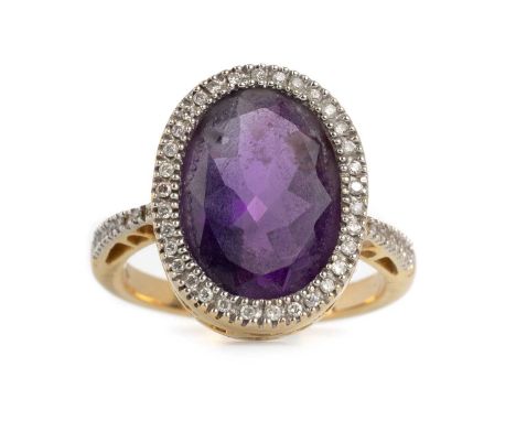 AMETHYST AND DIAMOND RING, EIGHTEEN CARAT GOLD  the oval amethyst in a surround of round brilliant cut diamonds and with diam