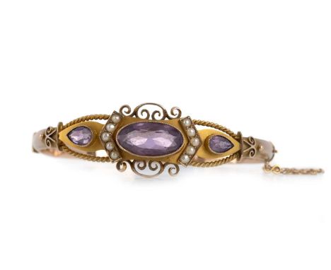 EDWARDIAN AMETHYST AND SEED PEARL BANGLE,  the central section set with oval and pear shaped amethysts, seed pearls and ropet
