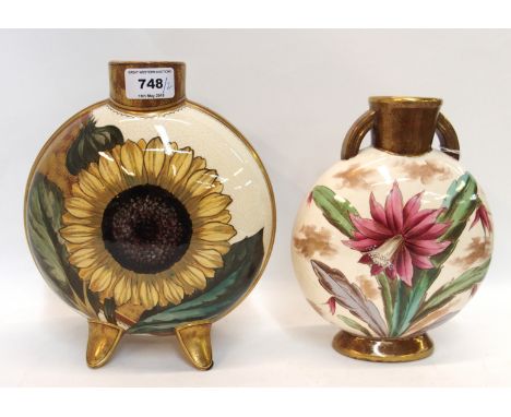 A pottery moon shaped vase with decoration of a sunflower to one side and an iris to the other 24cm high, together with a Add