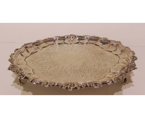 A silver card tray by Timothy Renou, London 1796, of circular form with foliate decorated rim, foliate decorated flat and cen