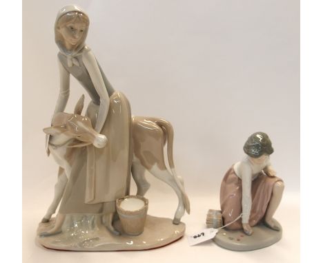 A Nao figure of a girl playing marbles and a Lladro figure of a girl and a calf, 33cm high Condition Report: Available upon r