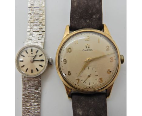 A 9ct gold cased gents vintage Omega watch diameter 3.3cm, weight including strap and mechanism 36.5gms, together with a ladi
