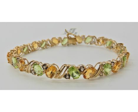 A 9ct gold peridot, citrine and smoky quartz set bracelet, length 19cm, weight 9gms Condition Report: Light general ware.
