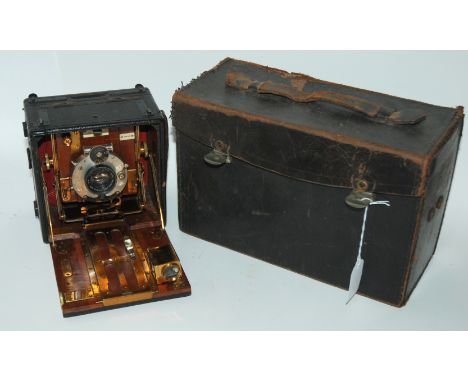 A vintage plate camera and a metal camera case with accessories Condition Report: Available upon request