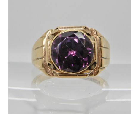 A 9ct gold gents ring set with a faux amethyst, finger size T, weight 9.5gms Condition Report: Available upon request