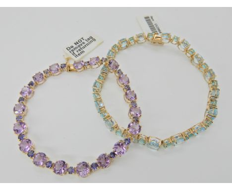 A 9ct gold amethyst and tanzanite line bracelet, length 18.5cm, together with a 9ct aquamarine and blue gem bracelet length 1