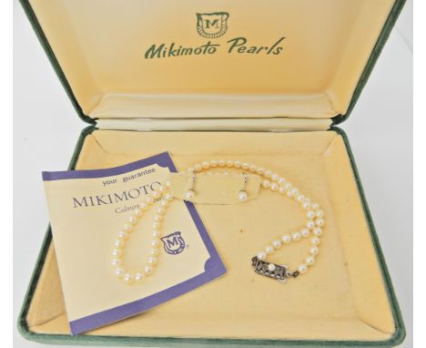 A string of Mikimoto pearls with silver clasp, length 39.5cm and a pair of silver matching earrings (no logo) Condition Repor