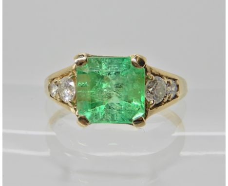 A 9ct gold emerald and diamond ring, emerald 7.9mm x 8mm x 5.5mm, set with four diamonds with a combined estimated approx dia