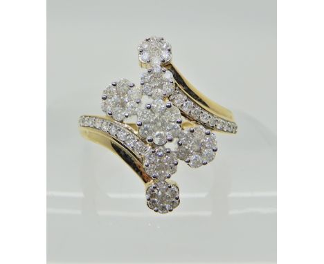 A 9ct yellow gold diamond flower ring, set with estimated approx 1ct of brilliant cut diamonds, size Q, weight 4.4gms Conditi