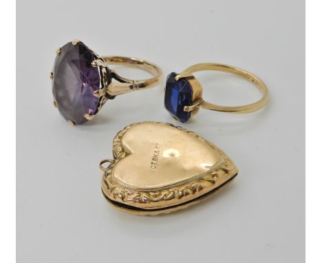 A 9ct gold large faux amethyst ring size O1/2, a 9ct blue glass set ring, size P and a heart shaped back and front locket, co