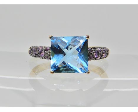 A 9ct gold blue topaz and amethyst set ring, finger size N1/2, weight 2.9gms Condition Report: Available upon request